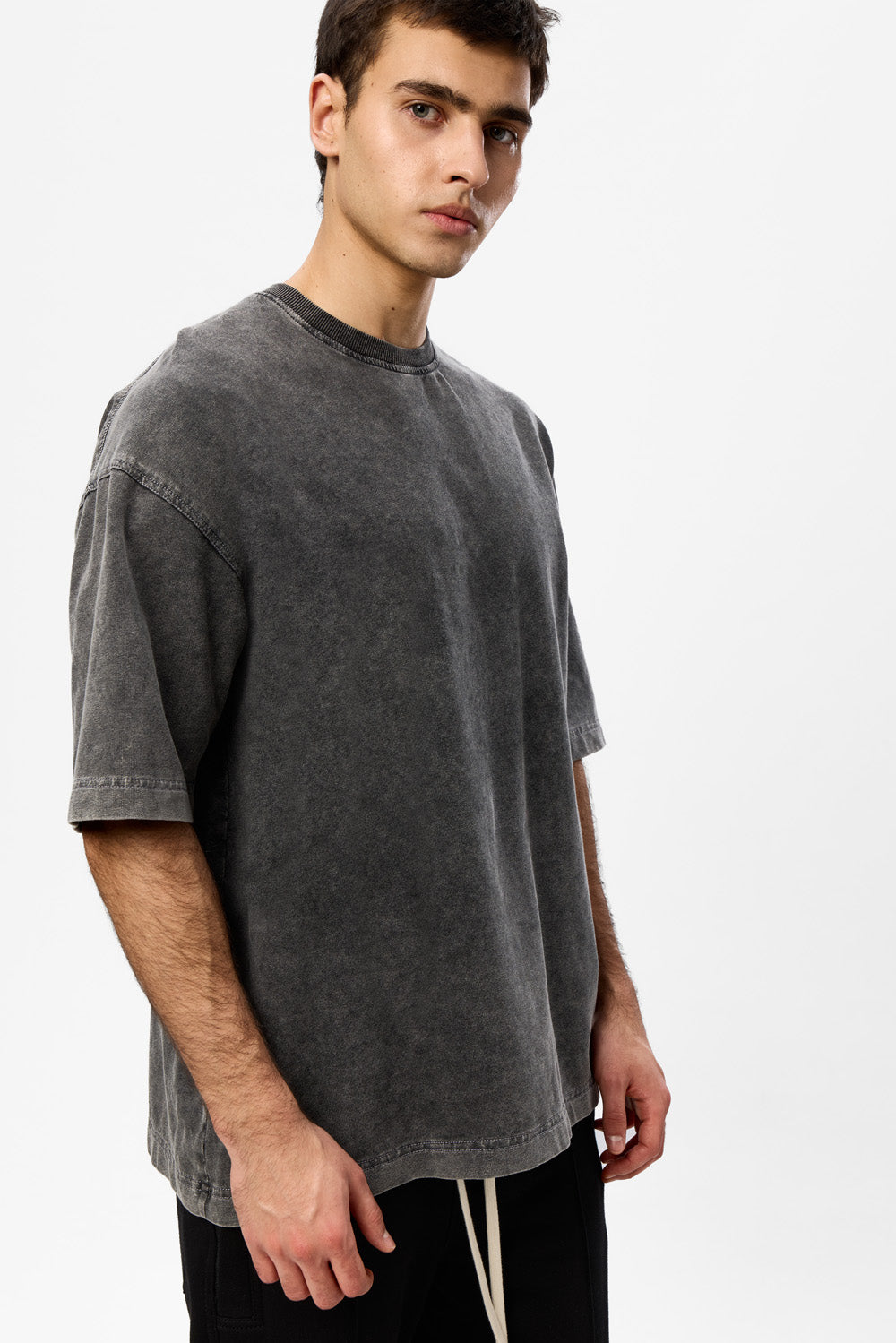 Vedere laterală a tricoului Storm Vintage gri Atelier Hamza, evidențiind croiala oversized, umerii căzuți și lungimea lejeră.